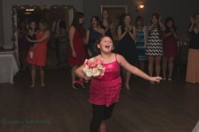 girl catches bouquet at wedding
