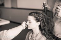 bride getting hair and makeup done